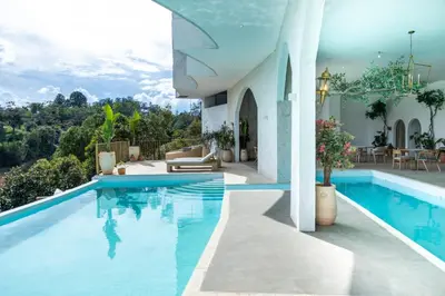 a villa with a swimming pool with a view at MYLOS Hotel Boutique in Guatapé