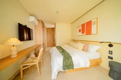 a bedroom with a bed and a desk and a chair at Moabi Hotel in Medellín