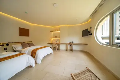 a bedroom with two beds and a window at Moabi Hotel in Medellín