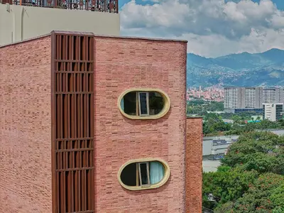 a brick building with two windows on the side of it at Moabi Hotel in Medellín