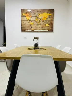 a table with white chairs and a map on the wall at Majana 1 in Jardin