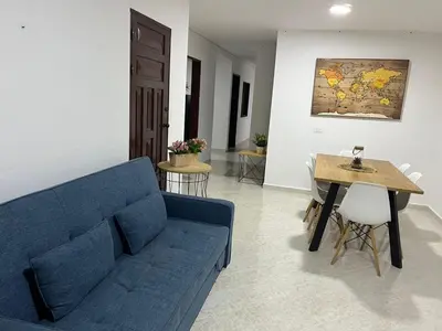 a living room with a blue couch and a table at Majana 1 in Jardin