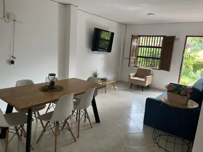 a living room with a wooden table and chairs at Majana 1 in Jardin