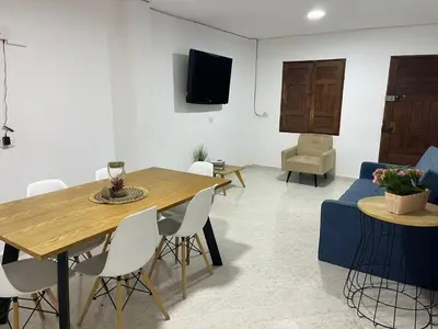a living room with a table and a couch at Majana 1 in Jardin