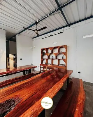 a room with two wooden tables and shelves in it at Casa del Cable in Mariquita