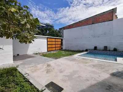 a house with a swimming pool next to a building at Casa del Cable in Mariquita