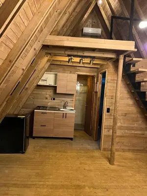 a kitchen with a sink and a stove in an attic at Glamping Verde Melcocho in San Francisco