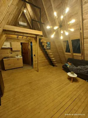 a large living room with a couch and a staircase at Glamping Verde Melcocho in San Francisco
