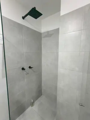 a bathroom with a shower with a glass door at Incleible Apartamento en Sabaneta in Sabaneta