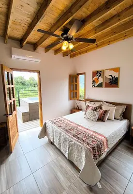a bedroom with a bed and a ceiling fan at Cabaña Solara in Jardin