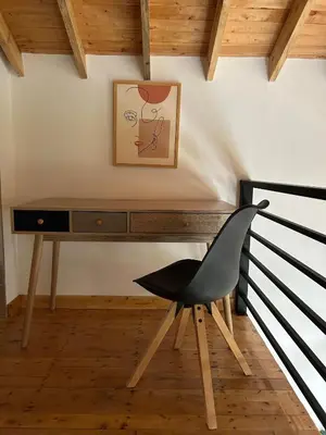 a desk with a chair and a picture on the wall at Cabaña Solara in Jardin