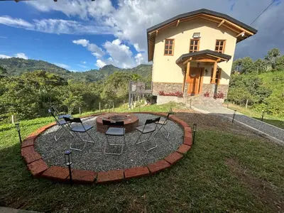 a circular fire pit in front of a house at Cabaña Solara in Jardin