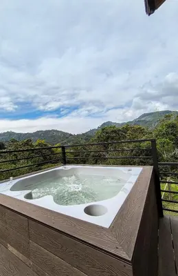 a jacuzzi tub with a view of the mountains at Cabaña Solara in Jardin