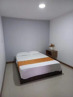 a bedroom with a bed in a white room at Apartment FL101 in Manizales