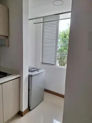 a small kitchen with a washer and a window at Apartment FL101 in Manizales