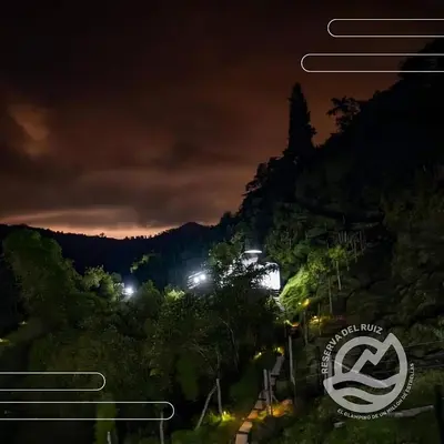 a view of a mountain at night at Glamping Reserva del Ruiz in Villamaría