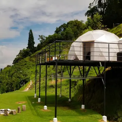 a dome house on display in a field at Glamping Reserva del Ruiz in Villamaría