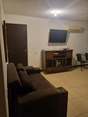 a living room with a couch and a flat screen tv at Apartasol Familiar 2 in Santa Fe de Antioquia