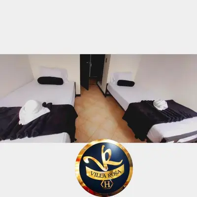 a hotel room with two beds with a sign on it at HOTEL VILLA ROSa in Medellín