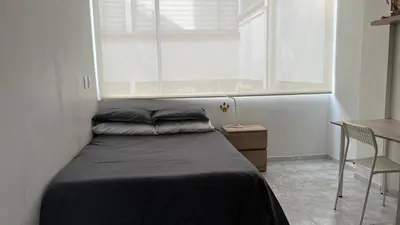 a small bedroom with a bed and a window at Apartamento 3 habitaciones 2 baños Vista Panoramica - Av Santander Sector El Cable y Estadio Palogrande in Manizales