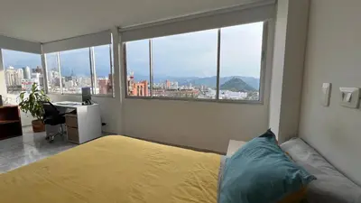 a bedroom with a bed and a desk with a window at Apartamento 3 habitaciones 2 baños Vista Panoramica - Av Santander Sector El Cable y Estadio Palogrande in Manizales