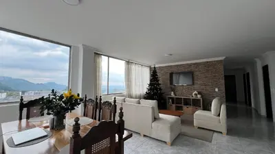 a living room with a table and chairs at Apartamento 3 habitaciones 2 baños Vista Panoramica - Av Santander Sector El Cable y Estadio Palogrande in Manizales