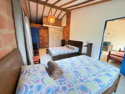 a bedroom with two beds in a room at Villa Manantiales con baño turco y Jaquzzi in Carolina del Principe