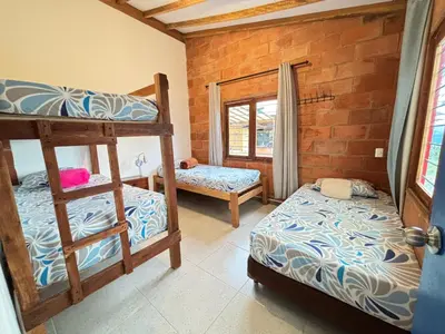 a room with two bunk beds and a window at Villa Manantiales con baño turco y Jaquzzi in Carolina del Principe