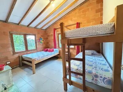 a room with two bunk beds and two windows at Villa Manantiales con baño turco y Jaquzzi in Carolina del Principe