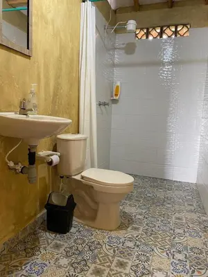 a bathroom with a toilet and a sink at Villa Manantiales con baño turco y Jaquzzi in Carolina del Principe