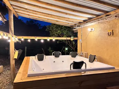 a large bath tub with four chairs in it at Villa Manantiales con baño turco y Jaquzzi in Carolina del Principe