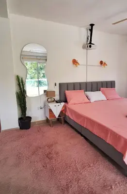 a bedroom with two beds and a red rug at OSIMiRI JAMAICA Ríos cristalinos, naturaleza y tranquilidad in San Rafael