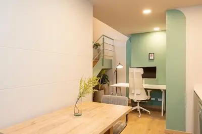 a room with a table and a desk and a chair at StrataSix Hotel in Medellín