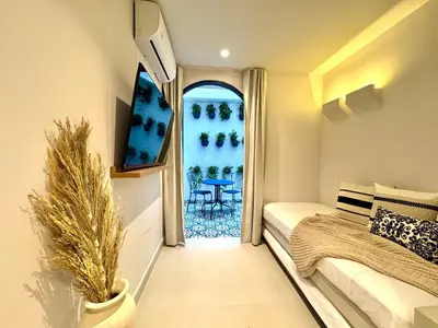 a bedroom with a bed and a window with a table at Villa kalah in Puerto Triunfo