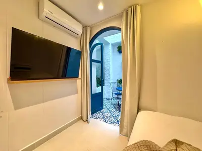 a bedroom with a bed and a door to a patio at Villa kalah in Puerto Triunfo