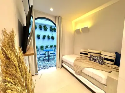 a bedroom with a bed and a window with a table at Villa kalah in Puerto Triunfo
