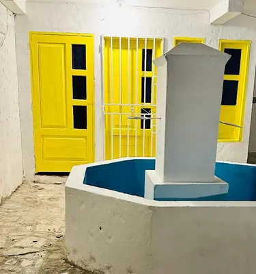 a yellow door and a blue and white building at Santorini Colombiano in Puerto Triunfo