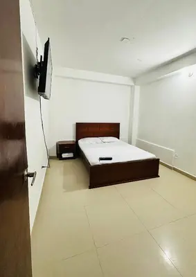 a bedroom with a bed and a flat screen tv at Santorini Colombiano in Puerto Triunfo