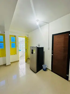 a kitchen with a refrigerator in the middle of a room at Santorini Colombiano in Puerto Triunfo