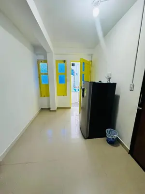 a kitchen with a refrigerator in a room at Santorini Colombiano in Puerto Triunfo