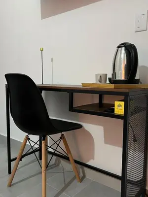 a black chair sitting in front of a wooden desk at Casa Blue Jericó in Jericó