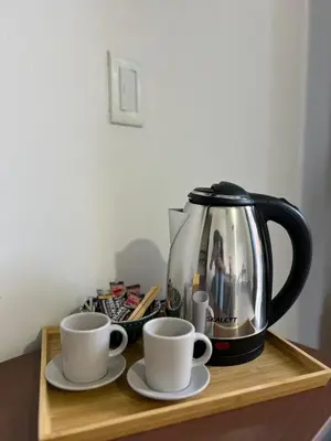 a tea kettle and two cups on a wooden tray at Casa Blue Jericó in Jericó