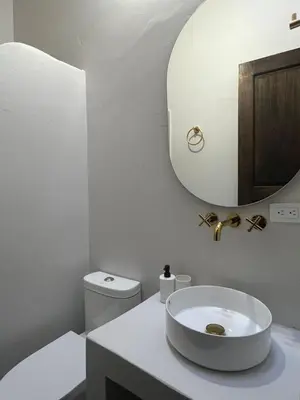 a white bathroom with a sink and a mirror at Casa Blue Jericó in Jericó