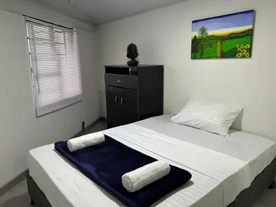 a bedroom with a bed with two towels on it at Apartamento en Manizales in Manizales
