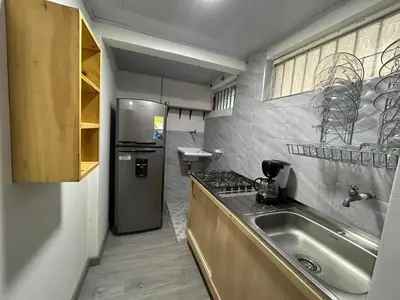 a small kitchen with a sink and a refrigerator at Apartamento en Manizales in Manizales