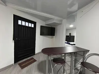 a room with a table and chairs and a door at Apartamento en Manizales in Manizales