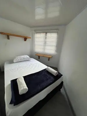 a bedroom with a bed with two towels on it at Apartamento en Manizales in Manizales