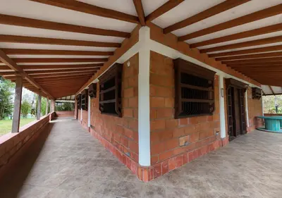 a brick building with a wooden roof with windows at Paraiso del Nomada in Barbosa