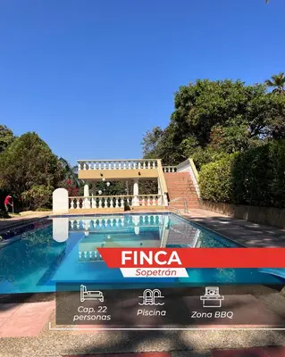a swimming pool in front of a building at finca de recreo in Sopetran