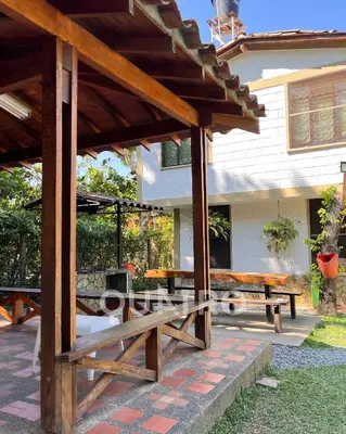 a patio with two wooden benches and a table at finca de recreo in Sopetran
